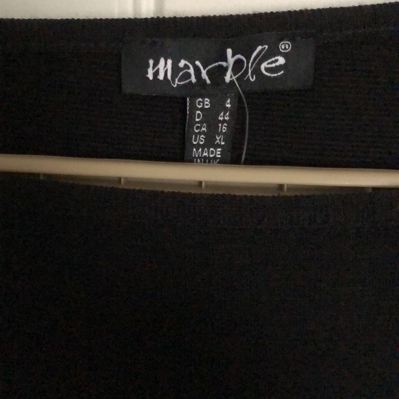 Sweater with open slots down the button sleeves. - Picture 3 of 5